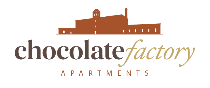 A logo for chocolate factory apartments featuring a brown building.